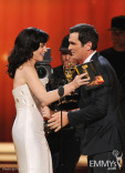 (L-R) Julianna Margulies presenting Ty Burrell with the award for Outstanding Supporting Actor in a Comedy Series 