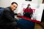 Harry Lennix signs.