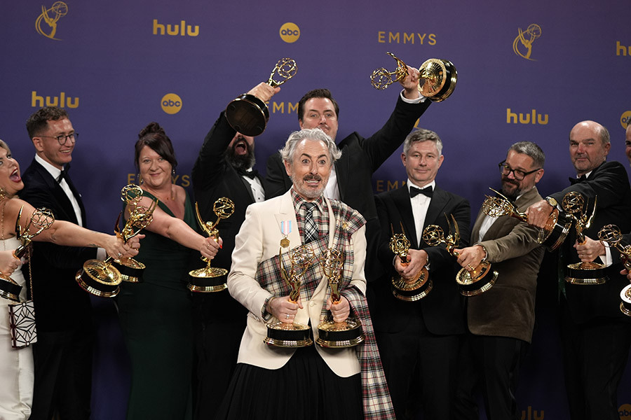 Alan Cumming and the team from The Traitors backstage with the award for Outstanding Reality Competition Program at the 76th Emmy Awards