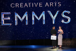 Jade Davis (left) and Greta Casagrande onstage with the Ernst & Young briefcase at the 2025 Creative Arts Emmys