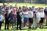 Golf classic participants pose for a photo. 