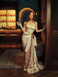 Abby Elliott wearing a cream-colored gown in the Emmy Photo Studio