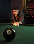 Charlie Evans plays pool in the Emmy Photo Studio
