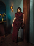 Fiona Dourif in a red dress posing in the Emmy Photo Studio
