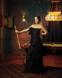 Grace Gummer poses at a pool table in a strapless black gown in the Emmy Photo Studio