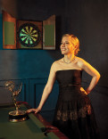Katie Dippold in a black gown posing with her Emmy Award