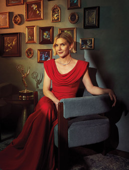 Rhea Seehorn in a red gown, posing with her Emmy Award