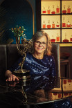 Sally Field in a blue gown posing with her Emmy Award