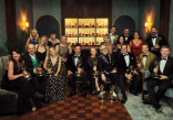 The cast and crew of The Traitors poses with their Emmy Awards