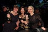 (From left) Cally Marriage, Sarah Pack, and Rosie Franks, winners of Outstanding Reality Competition Program for The Traitors, has their statuettes personalized during the 78th Emmy Awards Governors Gala