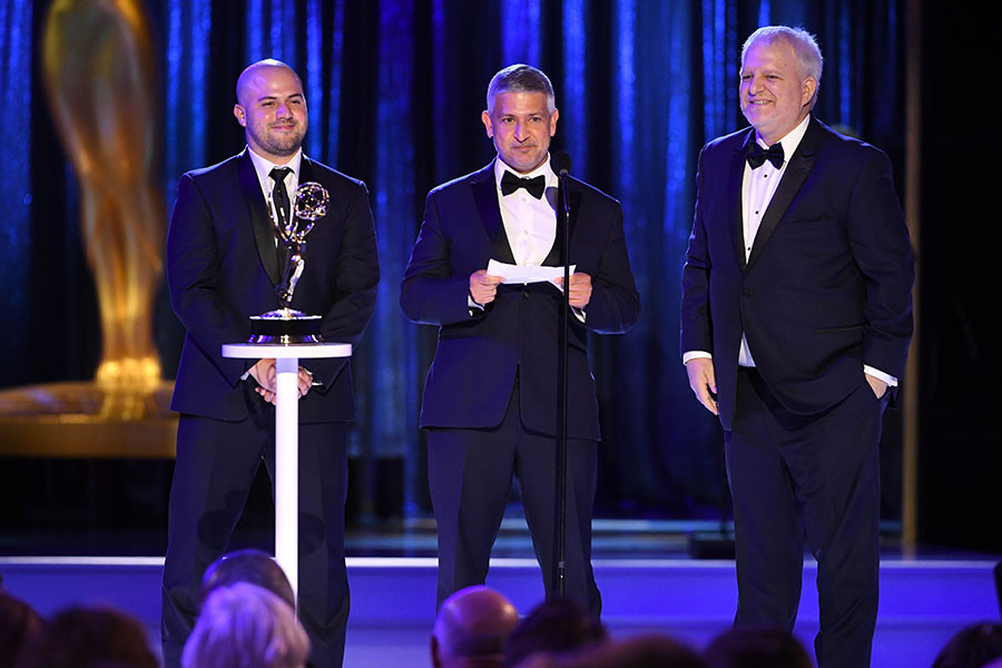 Eduardo Guisandes, Efrain Montanez and Jerry Torgerson accept an award at the 2021 Creative Arts Emmys.