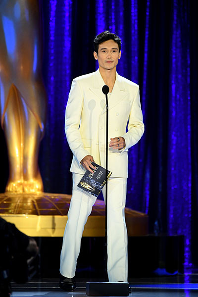 Manny Jacinto presents an award at the 2021 Creative Arts Emmys.