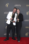 Giles Gale and Sidonie Roberts pose with their award for Outstanding Contemporary Costumes For A Series For The Crown backstage at the 76th Creative Arts Emmy Awards