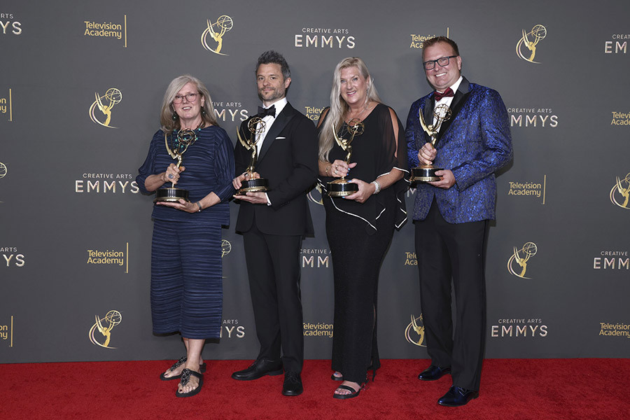 Helen Jarvis, Chris Beach, Lisa Lancaster, and Jonathan Lancaster pose with their award for Outstanding Production Design for a Narrative Period or Fantasy Program (One Hour or More) for Shōgun backstage at the 76th Creative Arts Emmy Awards