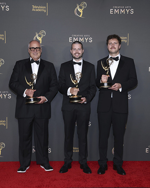 Michael Minkler, Duncan McRae, and Thor Fienberg pose backstage with their award for Outstanding Sound Mixing for a limited or anthology series or movie for Masters of the Air at the 76th Creative Arts Emmy Awards