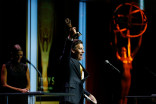 Christopher Wolfe accepts accepts the fictional “Best Acting Performance by a News Personality” award at the 67th Los Angeles Area Emmy Awards July 25, 2015, at the Skirball Cultural Center in Los Angeles, California.