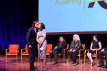 Actor Sam Heughan greets moderator Michelle Miller at the Outlander: From Scotland to Paris event, April 5, 2016, at the NYU Skirball Center for the Performing Arts in New York City. 