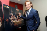 Actor Sam Heughan signs a poster at the Outlander: From Scotland to Paris event, April 5, 2016, at the NYU Skirball Center for the Performing Arts in New York City. 