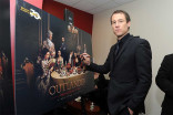 Actor Tobias Menzies signs a poster at the Outlander: From Scotland to Paris event, April 5, 2016, at the NYU Skirball Center for the Performing Arts in New York City. 