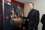Actor Tobias Menzies signs a poster at the Outlander: From Scotland to Paris event, April 5, 2016, at the NYU Skirball Center for the Performing Arts in New York City. 