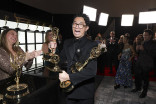 Lee Sung Jin from BEEF picking up his awards backstage at the 75th Emmy Awards