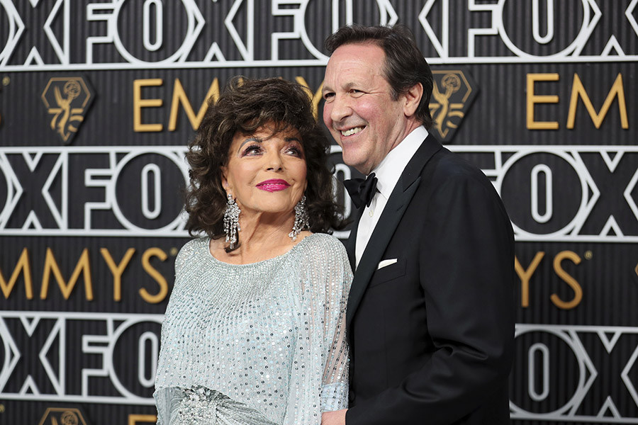 Joan Collins and Percy Gibson from The Time of Their Lives on the red carpet at the 75th Emmy Awards