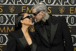 Kourtney Kardashian and Travis Barker on the red carpet at the 75th Emmy Awards
