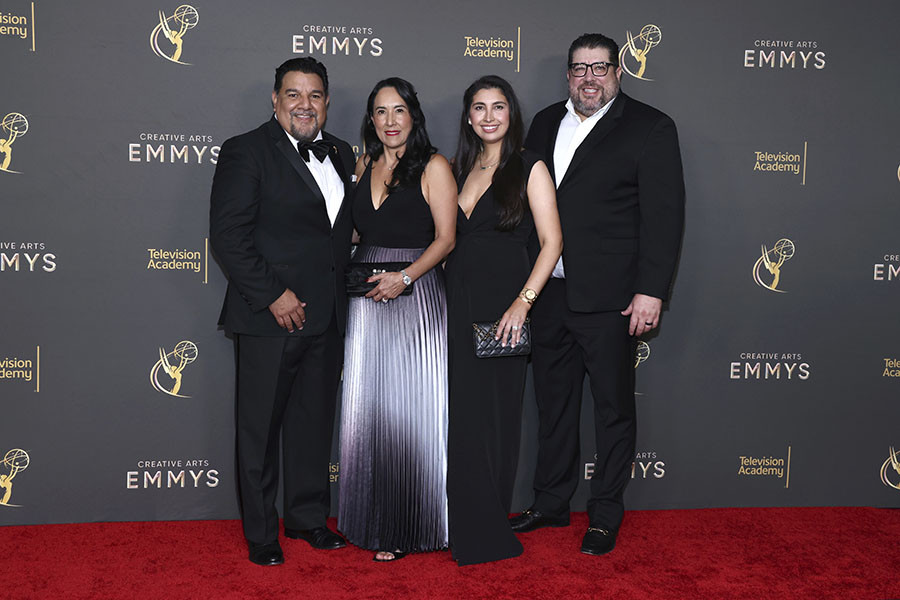 Cris Abrego, Adriana Abrego, and guests pose backstage at the 76th Creative Arts Emmy Awards 