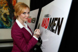 Christina Hendricks signs the poster at &quot;A Farewell to Mad Men,&quot; May 17, 2015 at the Montalbán Theater in Hollywood, California.