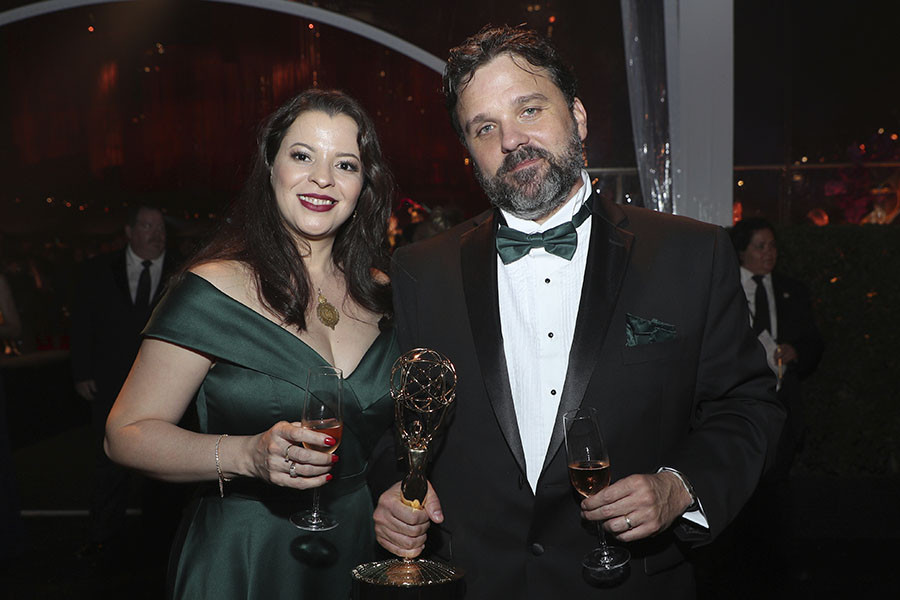 Livia Soares and Alessandro Soares pose with an award at the 2019 Creative Arts Ball.