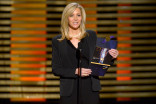 Lisa Kudrow presents an award at the 2014 Primetime Creative Arts Emmys.
