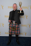 Neville Kidd celebrates at the 2014 Primetime Creative Arts Emmys.