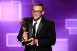 Justin Lebens accepts an award at the 2015 Creative Arts Emmys. 