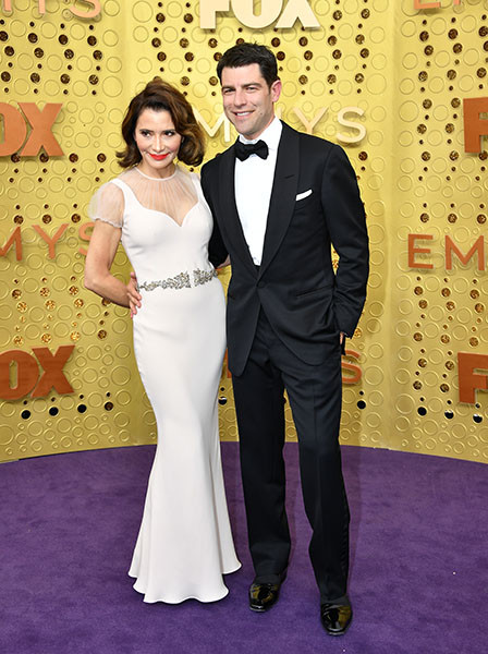 Tess Sanchez and Max Greenfield on the red carpet at the 71st Emmy Awards.