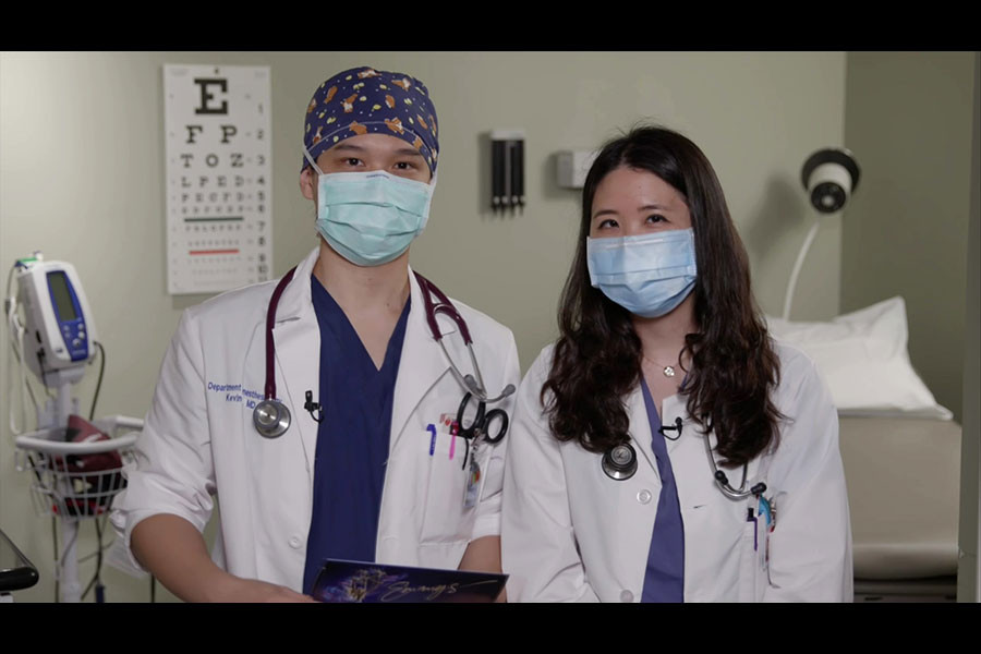 Kevin Tsai, left, and Karen Tsai, essential workers and doctors, present the Emmy for Outstanding Supporting Actor in a Drama Series during the 72nd Emmy Awards.