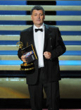 Steven Moffat of Sherlock accepts an award at the 66th Emmys.