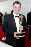 Sherlock writer Steven Moffat celebrates his win at the 66th Emmy Awards.