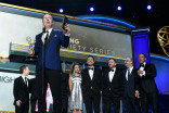John Oliver and team accept an award at the 69th Emmy Awards.