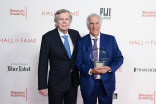 Henry Winkler holding an award standing next to Bob Daly