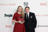 Suzan Mischer holding an award and standing next to Bob Costas