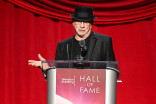 Mike Post wearing a black hat speaking as a podium