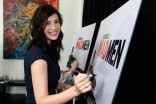  Jessica Paré signs the poster at &quot;A Farewell to Mad Men,&quot; May 17, 2015 at the Montalbán Theater in Hollywood, California.