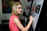 Kiernan Shipka signs the poster at &quot;A Farewell to Mad Men,&quot; May 17, 2015 at the Montalbán Theater in Hollywood, California.