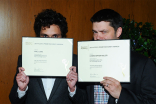 Phil Lord and Christopher Miller show off their certificates at the Directors nominee reception September 16, 2015, at the Directors Guild of America in Los Angeles, California.