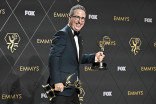 John Oliver backstage with his awards for Outstanding Scripted Variety Series and Outstanding Writing For A Variety Series for Last Week Tonight with John Oliver at the 75th Emmy Awards