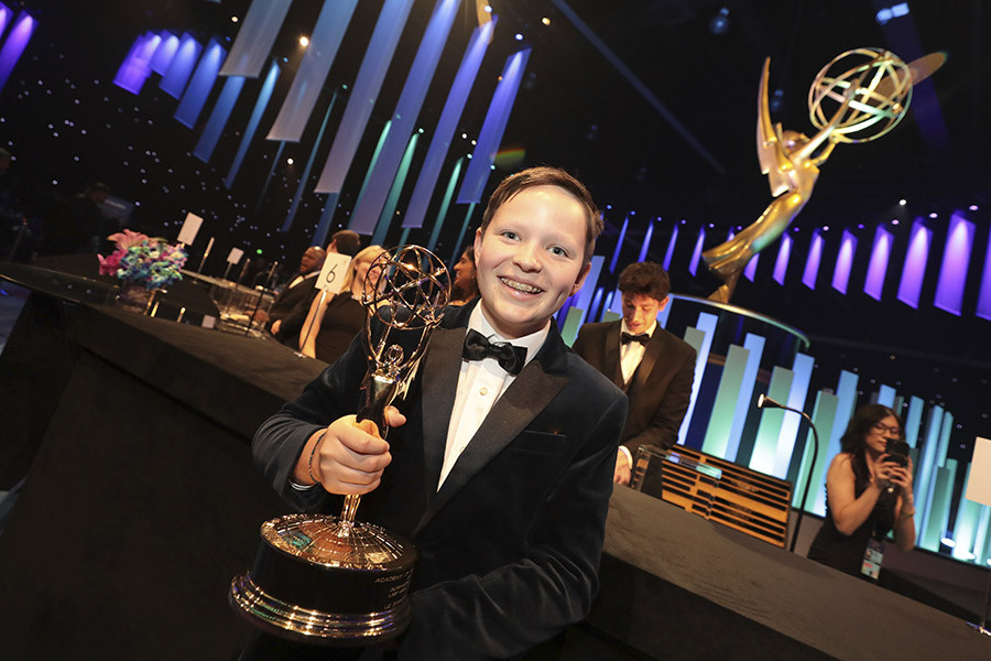 Grayson Caldwell poses with his mom's, Liz Stanton's of Last Week Tonight With John Oliver, award for Outstanding Scripted Variety Series at the 76th Emmy Awards Governors Gala