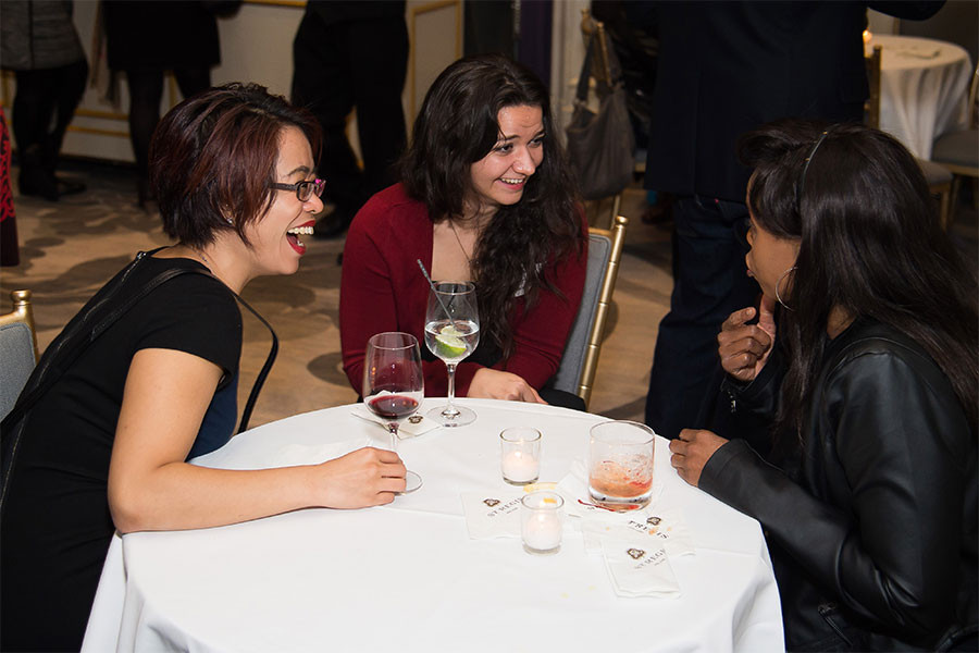 Stephanie Hui and Jenna Hellmuth chat with a friend at the New York Networking Night Out, November 13, 2015 at the St. Regis in New York City.